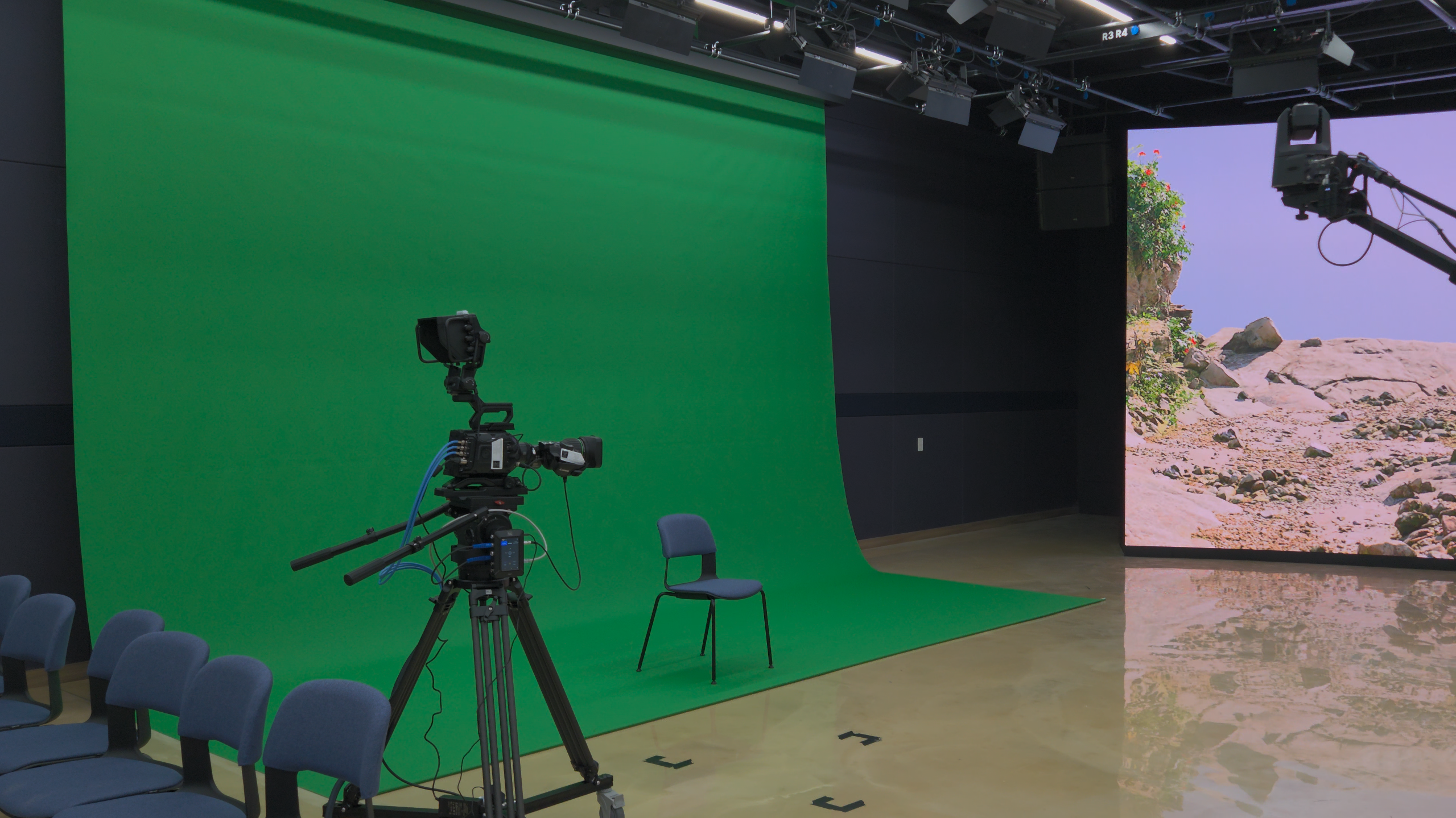 A real studio with the green-screen cyclorama and LED wall visible together